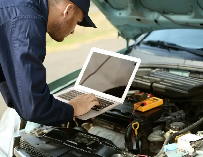 Imagen de un mecanico en un motor con una portatil